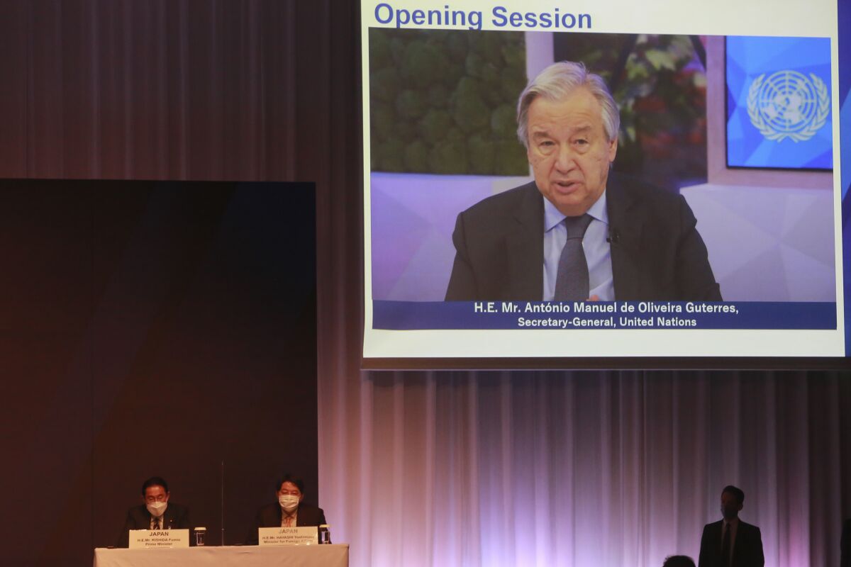 Secretary General of United Nations Antonio Guterres on a screen, speaks as Japanese Prime Minister Fumio Kishida ,left, and Foreign Minister Yoshimasa Hayashi listens during an online opening session of Tokyo Nutrition for Growth Summit in Tokyo, Tuesday, Dec. 7, 2021. (AP Photo/Koji Sasahara)