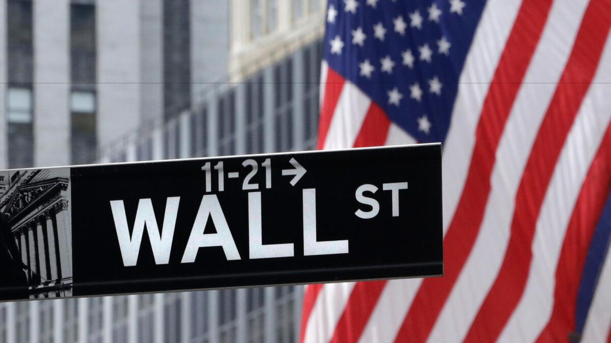 Flags fly at the New York Stock Exchange on Wall Street.