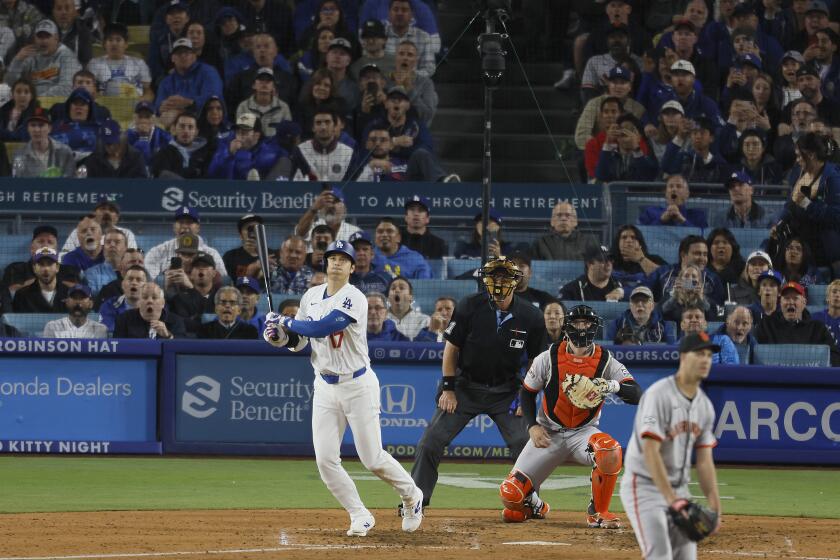 Los Angeles, CA - April 03: Dodgers designated hitter Shohei Ohtani, #17, hits his first home run as a Dodger off of Giants pitcher Taylor Rogers, # 33, in the seventh inning at Dodger Stadium in Los Angeles Wednesday, April 3, 2024. (Allen J. Schaben / Los Angeles Times)