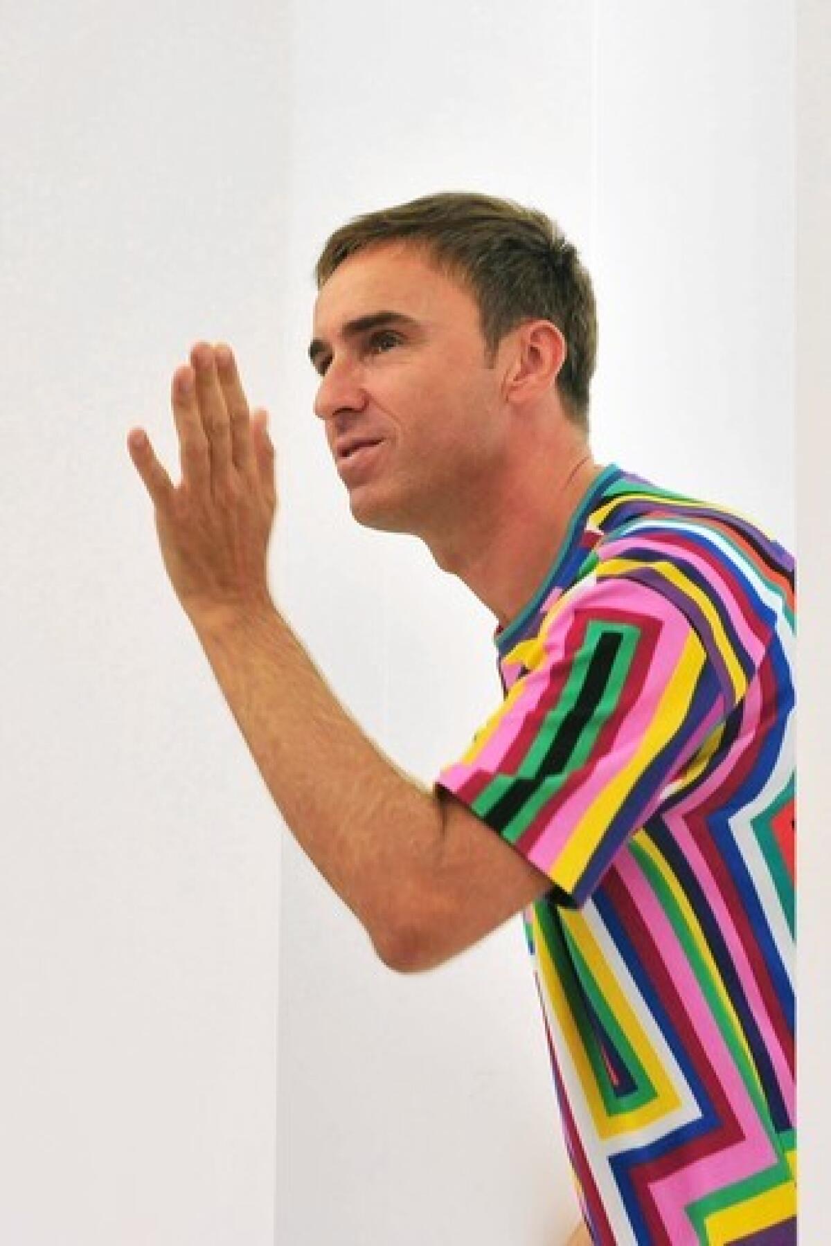 Belgian fashion designer Raf Simons acknowledges the audience at the end of Jil Sander Spring-Summer 2012 ready-to-wear collection on September 24, 2011 during the Women's Mialn fashion week.
