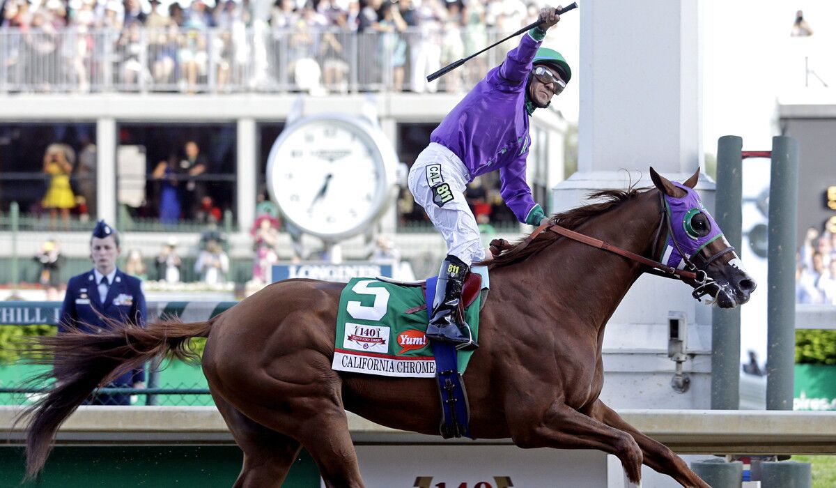 Jockey Victor Espinoza begins to celebrate after guiding California Chrome to victoryin the 140th running of the Kentucky Derby on Saturday at Churchill Downs in Louisville, Ky.