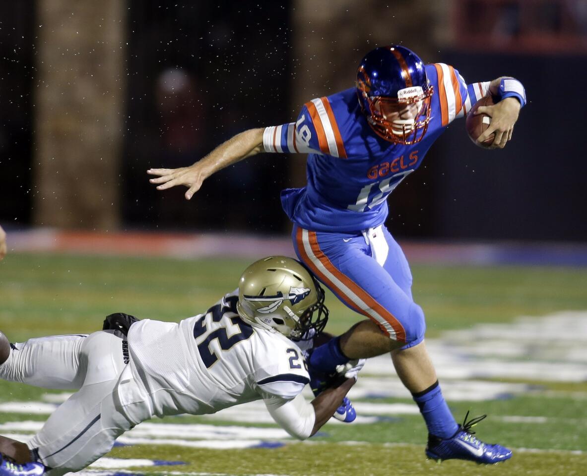 St. John Bosco safety Clifford Simms makes the tackle on Bishop Gorman quarterback Tate Martell in the first half.