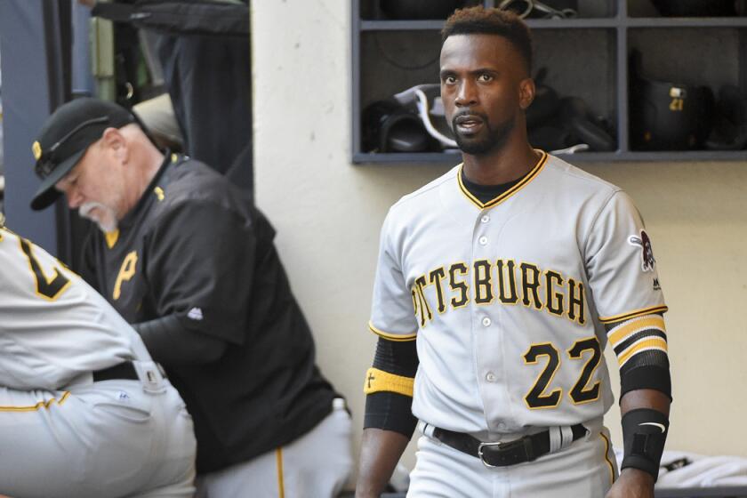 Pittsburgh Pirates' Andrew McCutchen watches the game from the dugout during the sixth inning against the Milwaukee Brewers on Sunday.