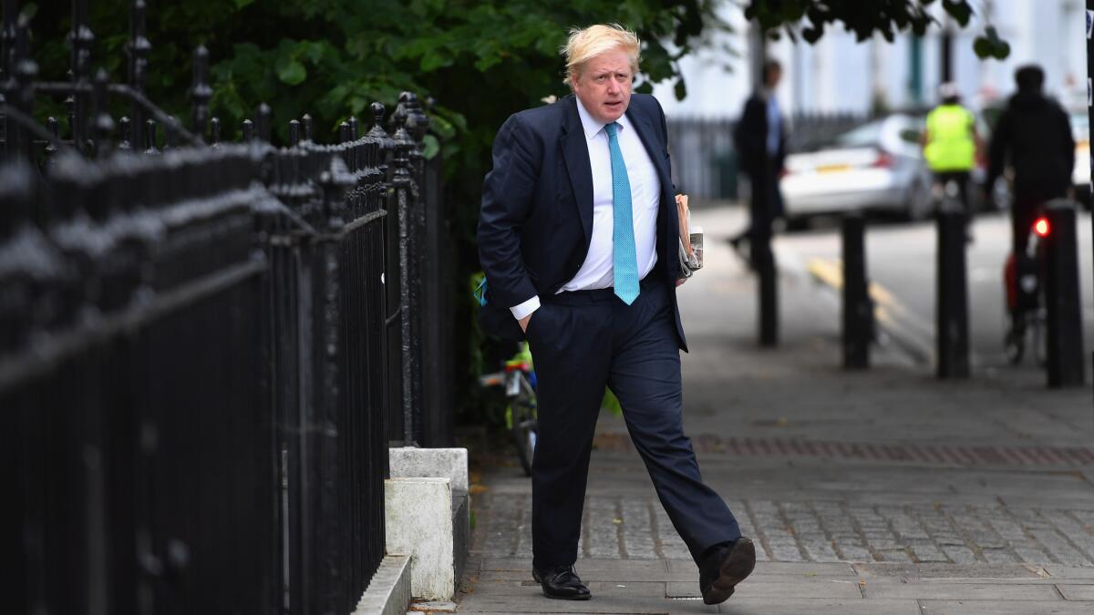 Former London Mayor Boris Johnson steps from his home on Wednesday.