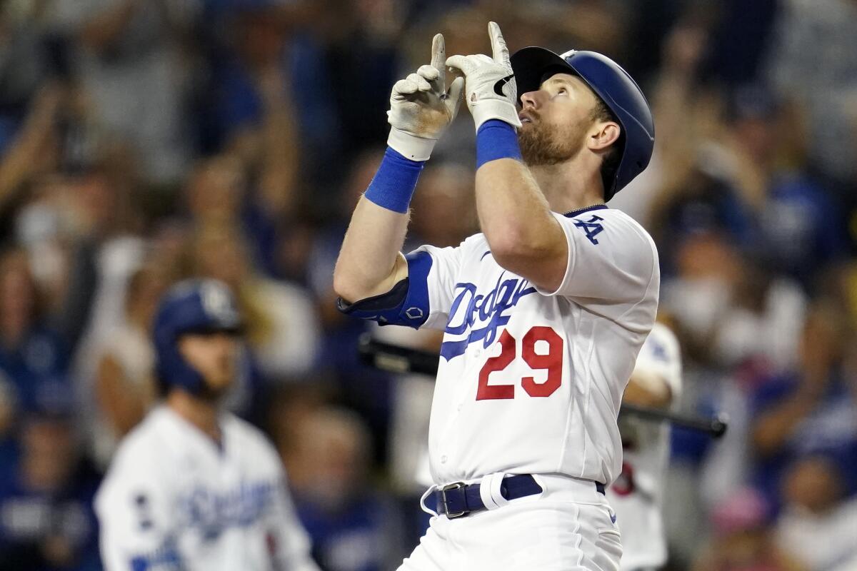 Dodgers' Billy McKinney celebrates his solo home run at home plate.