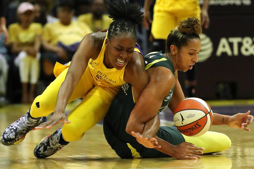LOS ANGELES, CA - SEPTEMBER 15, 2019: Los Angeles Sparks forward Nneka Ogwumike (30) and Seattle Storm forward Mercedes Russell (2) battle for a loose ball in the first half of the second round of the WNBA playoffs at Staples Center on September 15, 2019 in Los Angeles, California. (Gina Ferazzi/Los AngelesTimes)