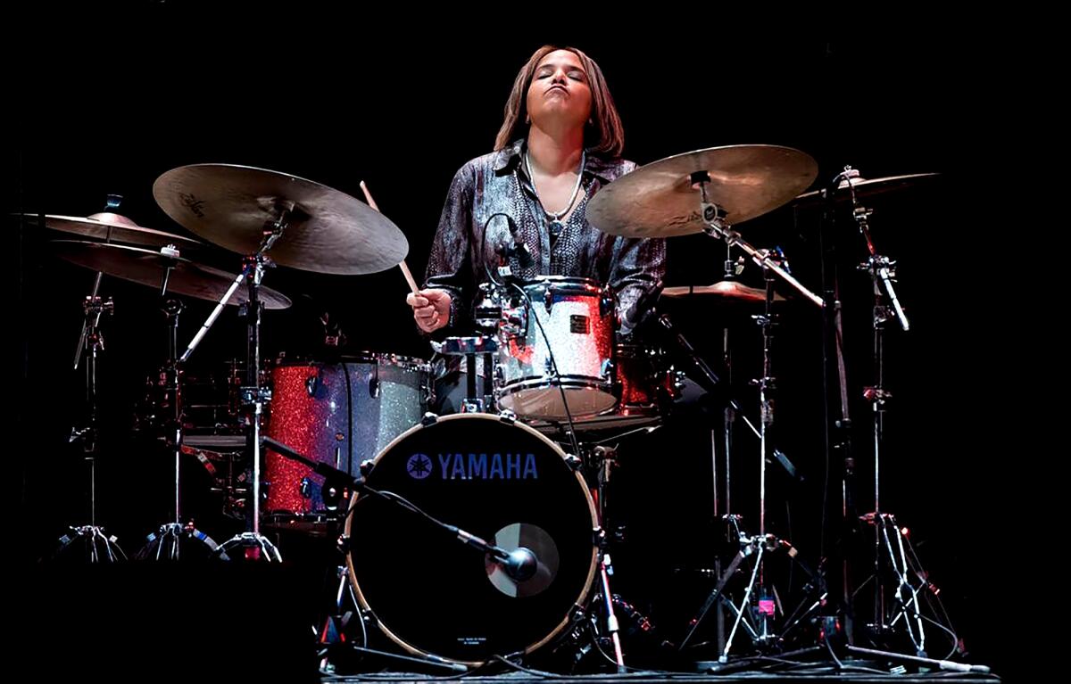 A woman playing the drums