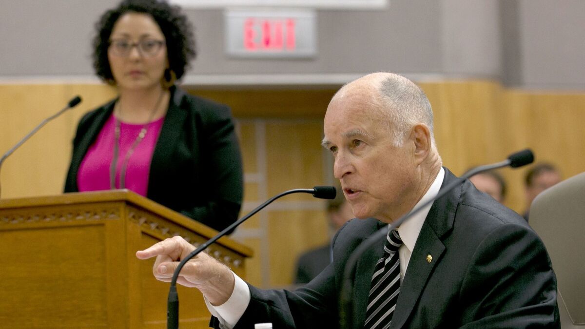 Assemblywoman Cristina Garcia (D-Bell Gardens), who chairs the Legislative Women's Caucus, listens to Gov. Jerry Brown at a July hearing in Sacramento.