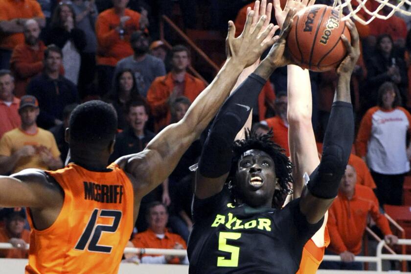 Baylor forward Johnathan Motley takes a shot over Oklahoma State forward Cameron McGriff (12) during the second half Wednesday night.