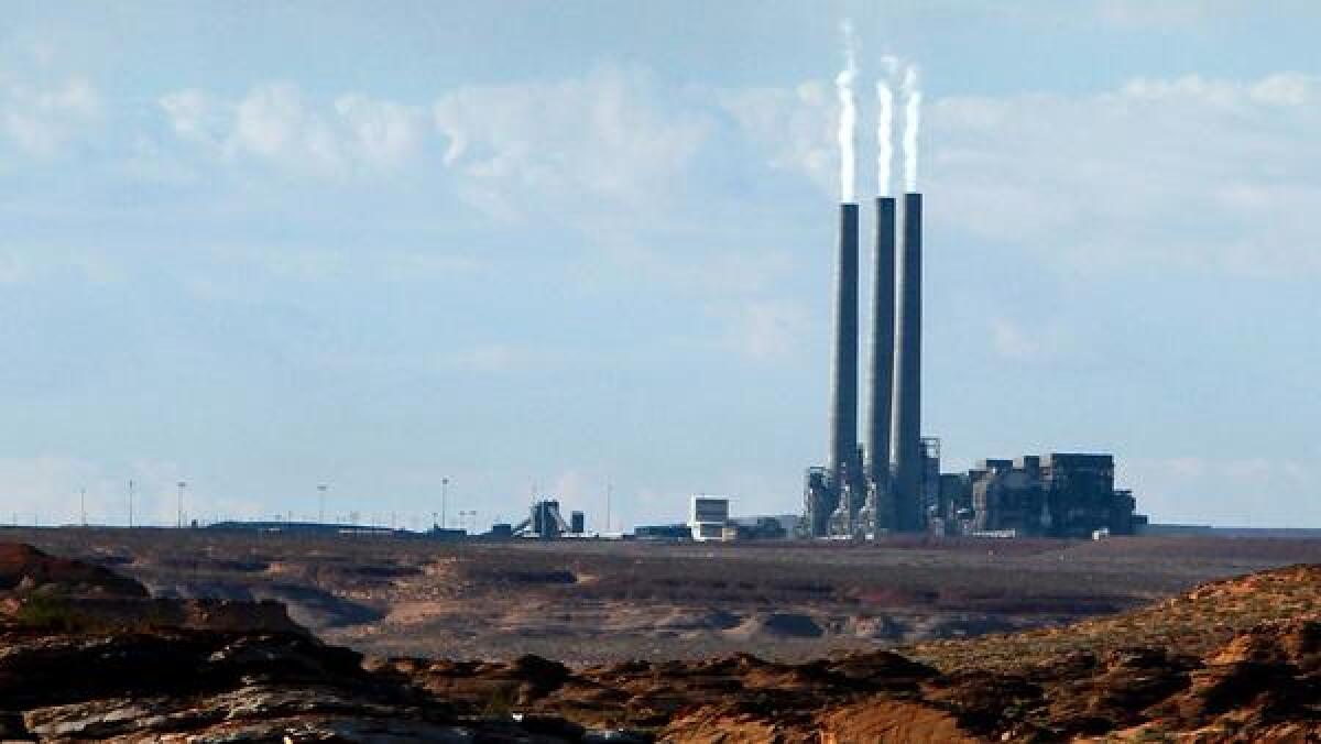 A power plant with three large smokestacks 