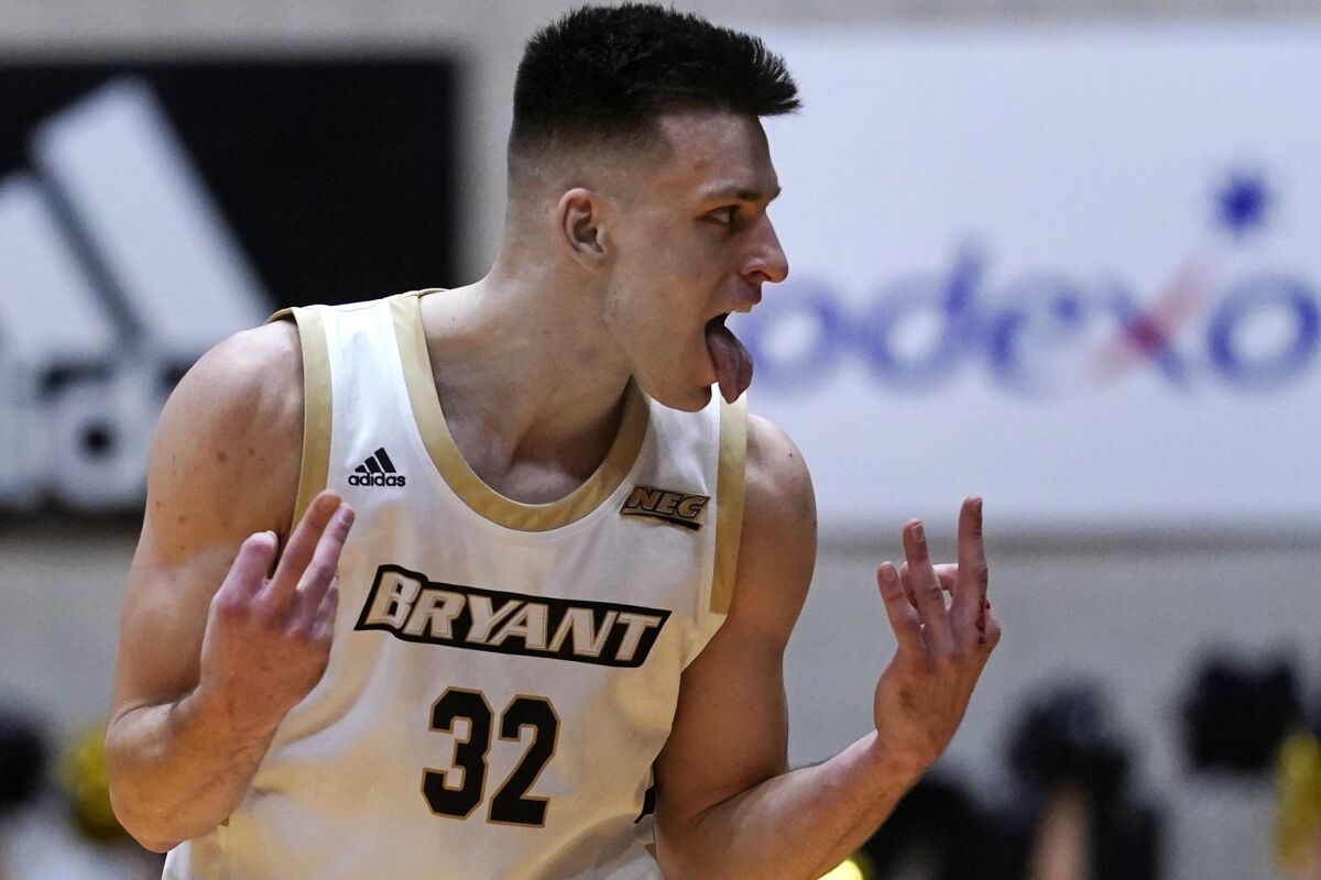 Bryant guard Peter Kiss celebrates after hitting a 3-pointer during the first half of the Northeast Conference men's NCAA college basketball championship game against Wagner, Tuesday, March 8, 2022, in Smithfield, R.I. (AP Photo/Charles Krupa)
