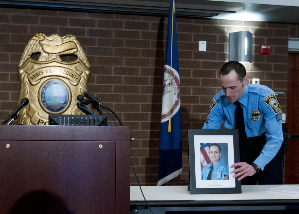 Prince William County Police Sgt. Jonathan L. Perok displays a picture of Officer Ashley Guindon, who was fatally shot Saturday, before a news conference Sunday.