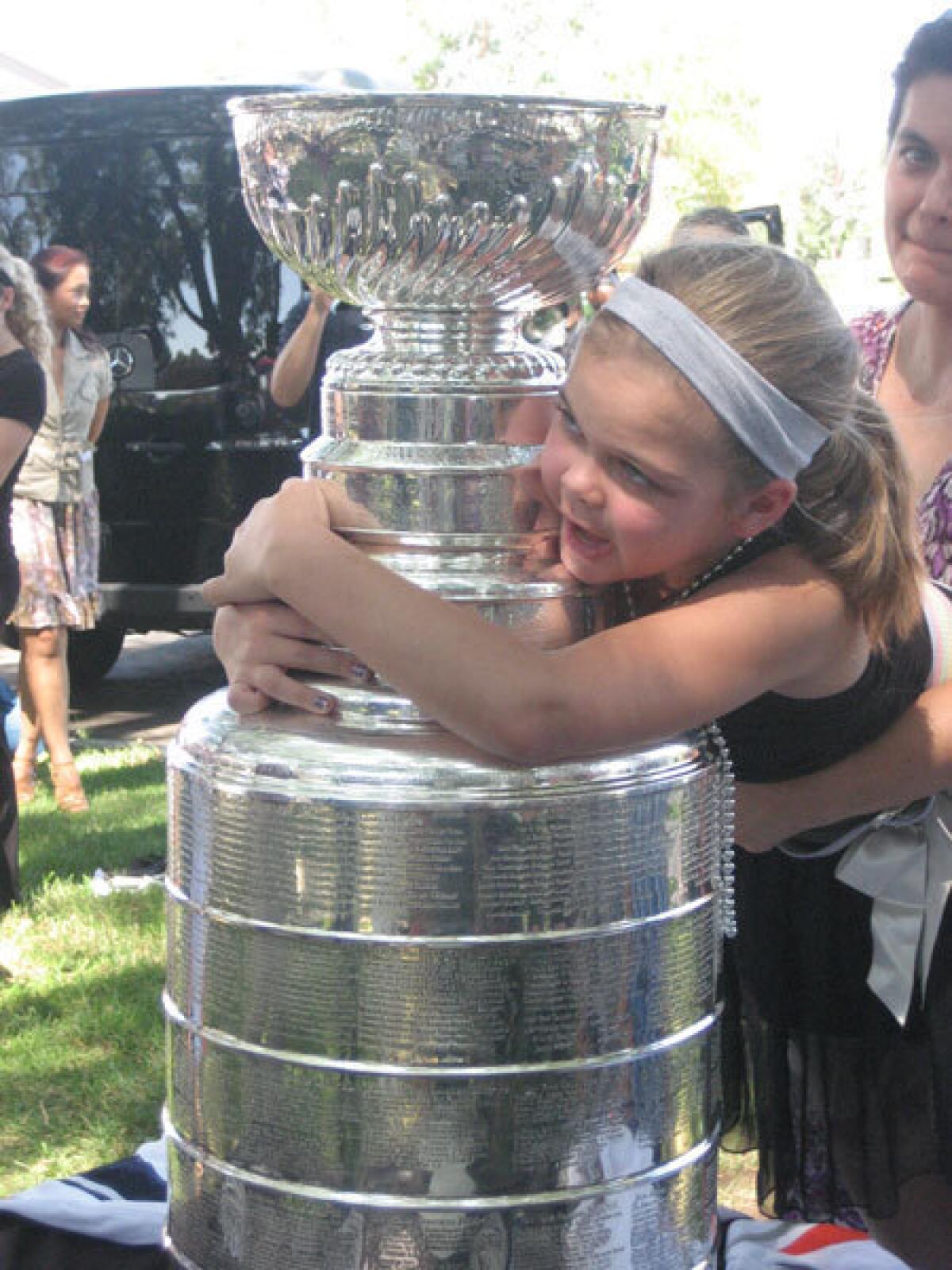 Genny Shepler hugs the Stanley Cup.