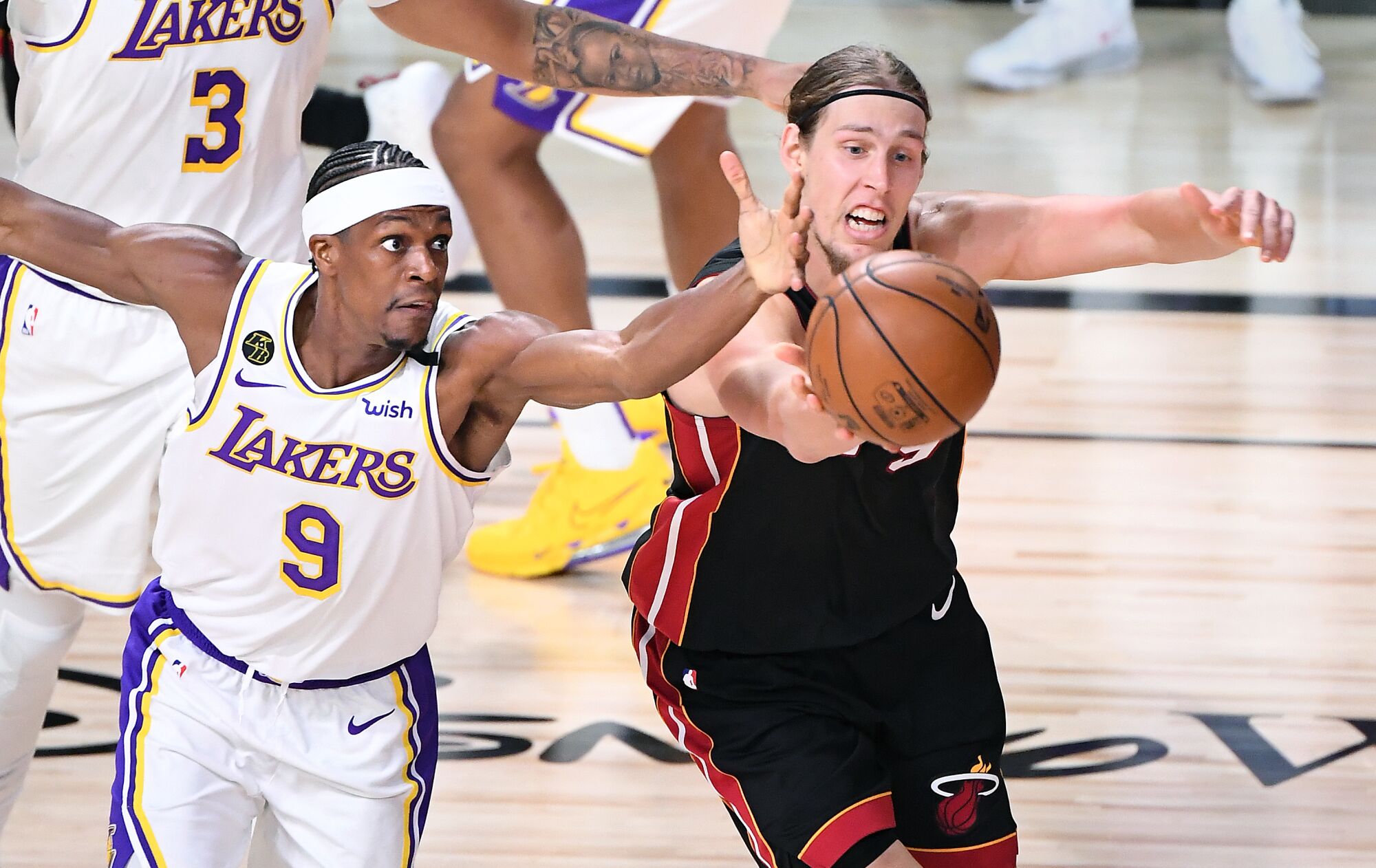 Lakers guard Rajon Rondo and Heat center Kelly Olynyk chase after a loose ball during Game 3.
