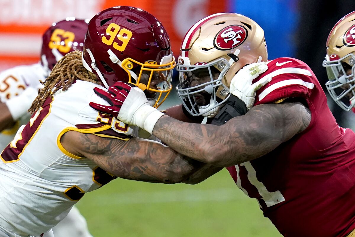 Washington defensive end Chase Young, left, battles San Francisco 49ers offensive tackle Trent Williams.