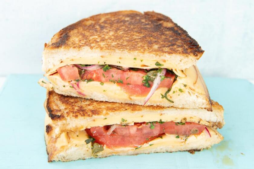 Smokey gouda is perfect for this grilled cheese sandwich, stuffed with bright, herby marinated tomatoes. Food styling by Ben Mims, with Julie Giuffrida. Props by Nina Cueva at PropLink in downtown Los Angeles.