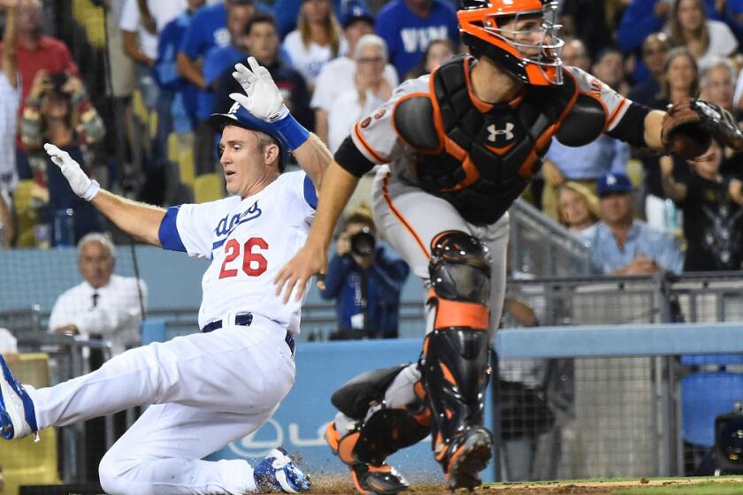 Chase Utley beats the throw to Giants catcher Buster Posey on Aug. 23.