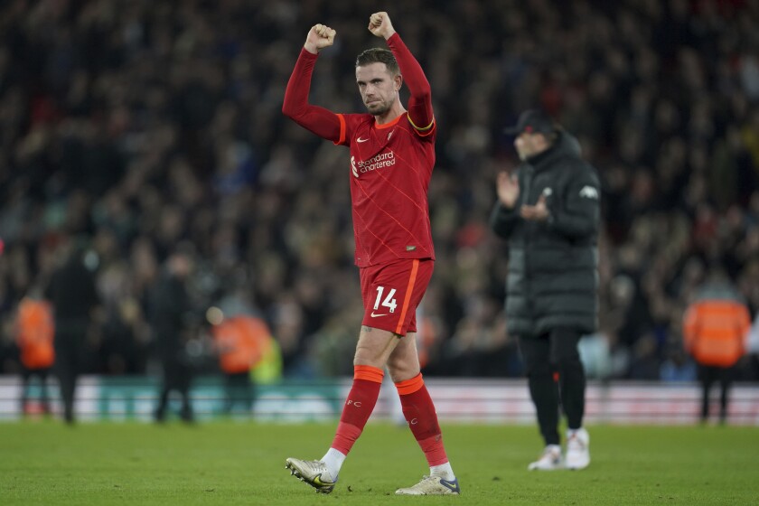 Liverpool's Jordan Henderson celebrates after their win in the English Premier League soccer match against West Ham United at Anfield stadium in Liverpool, England, Saturday, March 5, 2022. (AP Photo/Jon Super)