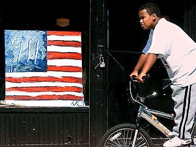"This was shot in the heart of Harlem. It's a very simple picture with a very complex meaning. What particularly caught my eye is the replacement of the stars and stripes with 911. The artist who did this is extremely creative. It's just tragic it had to happen this way."--Gary Friedman