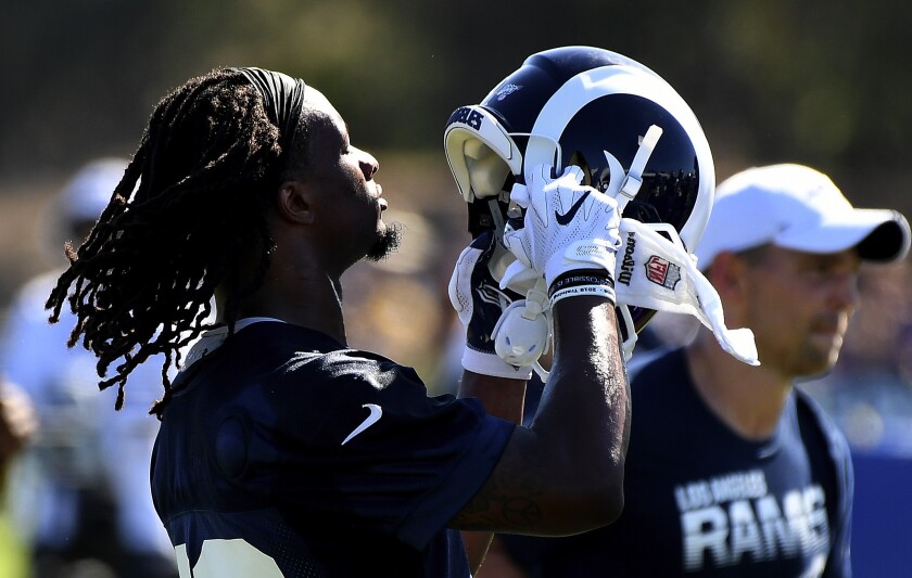 Rams running back Todd Gurley puts on his helmet during a training camp practice session in July.