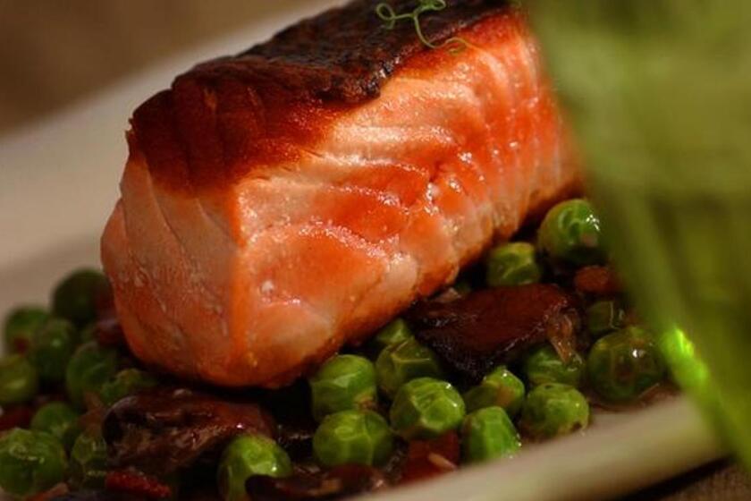 Recipe: Crispy-skinned wild salmon with braised spring peas and mushrooms