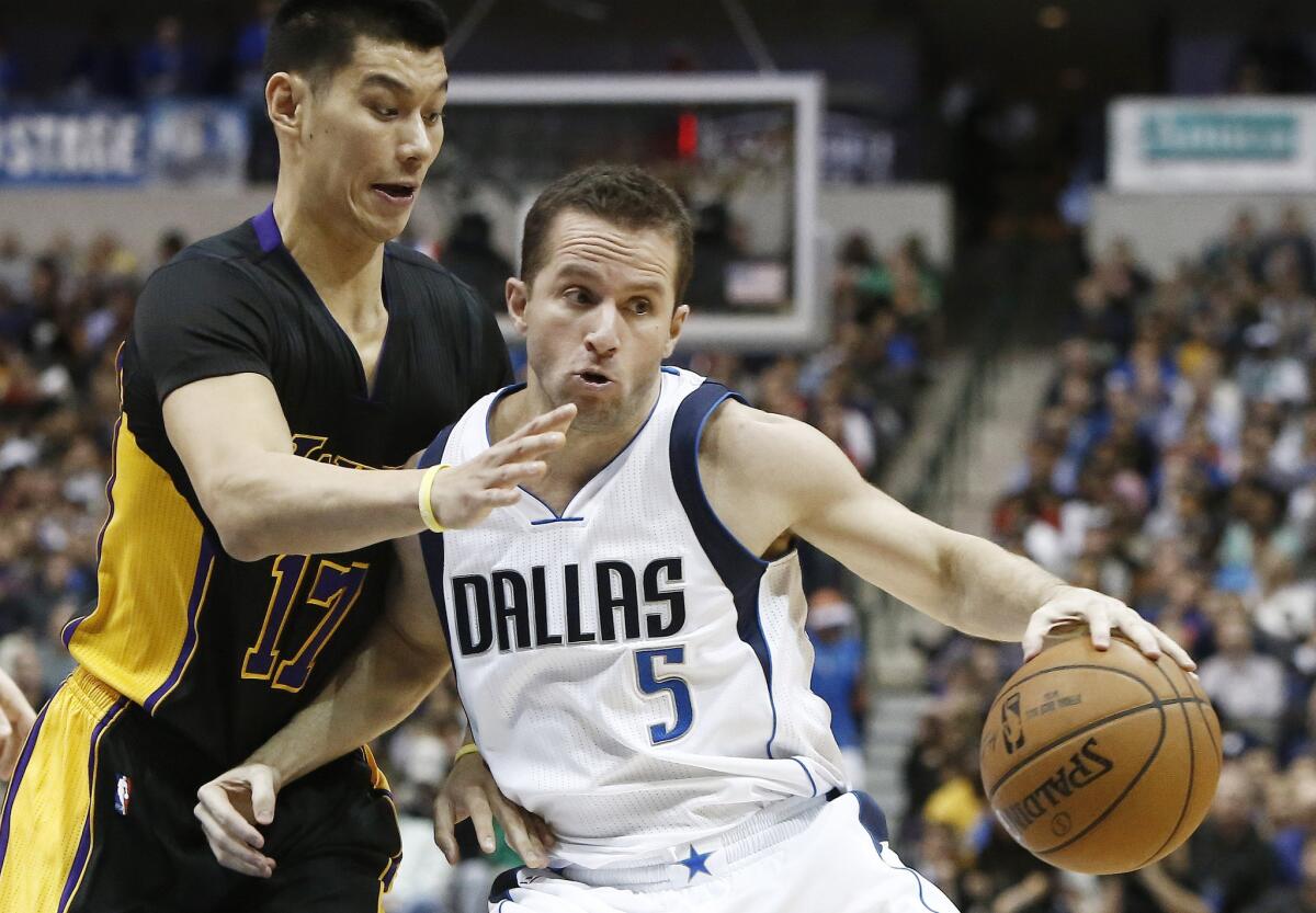 Lakers point guard Jeremy Lin tries to cut off a drive by Mavericks point guard J.J. Barea in the second half.