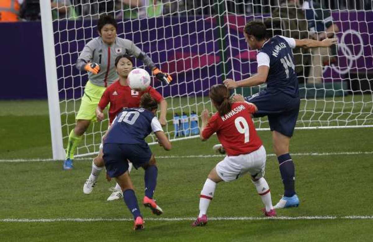 Carli Lloyd (10) scores against Japan as the U.S. takes a 1-0 lead over Japan into halftime in the gold-medal game at the London Olympics.