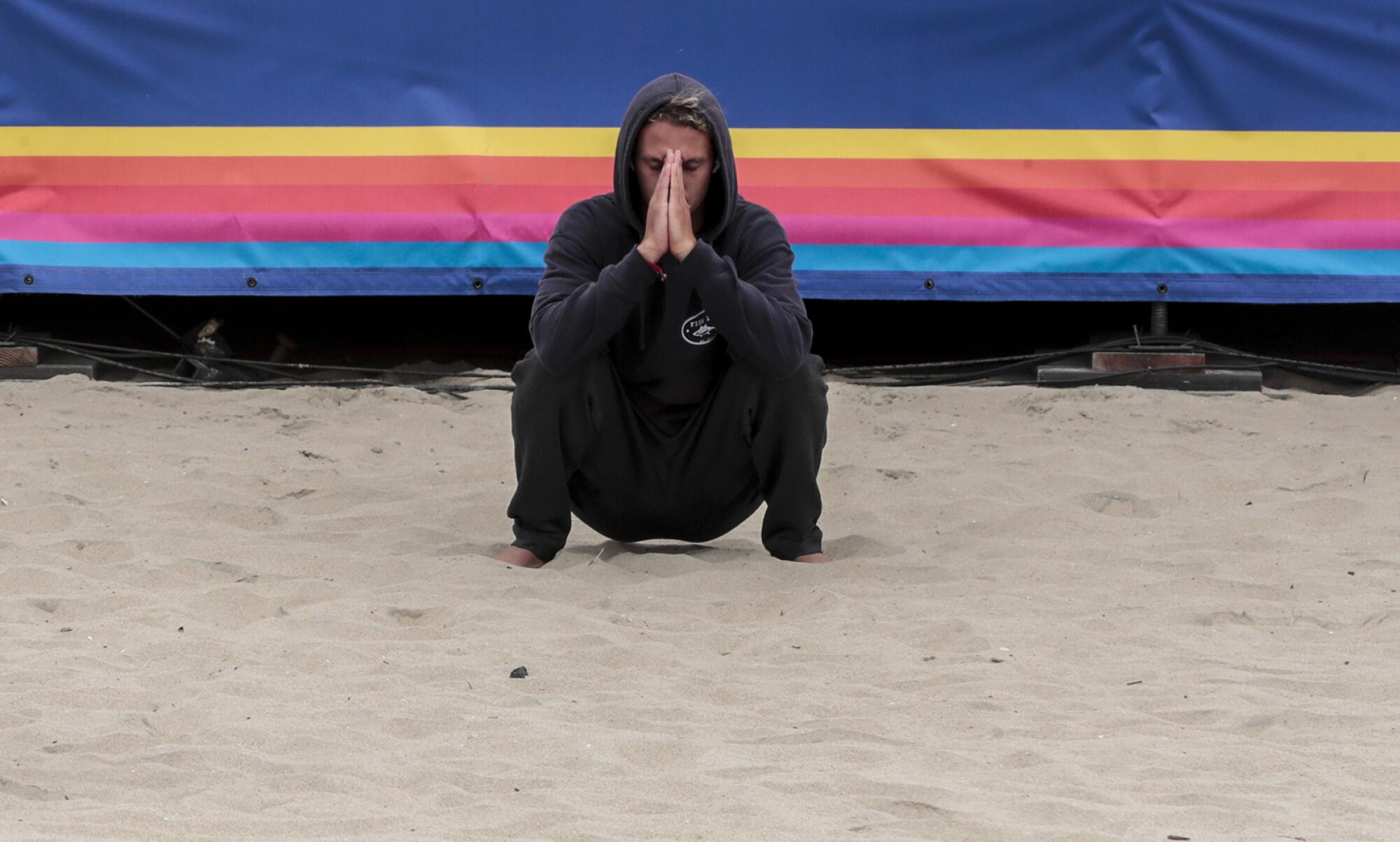 Surfer Jake Marshall stretches and meditates moments before competing in the finals