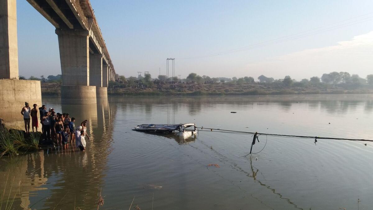 A bus is pulled from the Banas River after a deadly accident in Sawai Madhopur on Saturday.