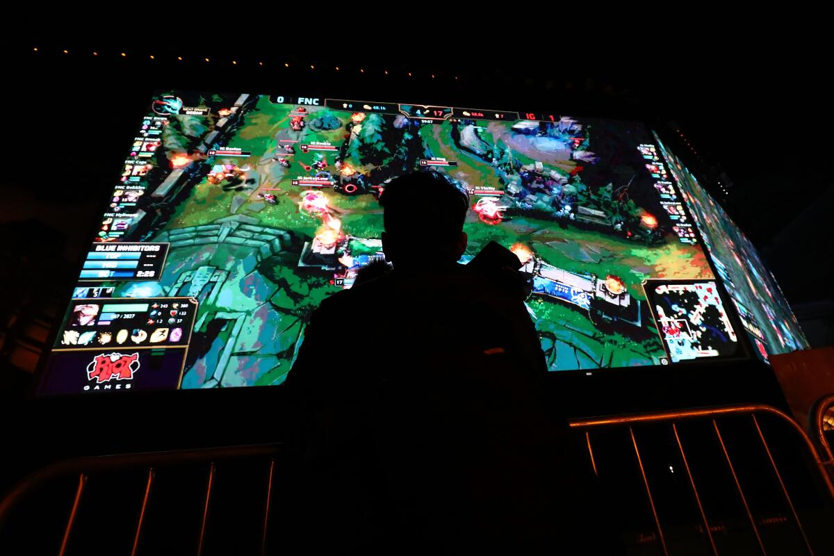 A fan watches the final match of the 2018 League of Legends World Championship in South Korea.