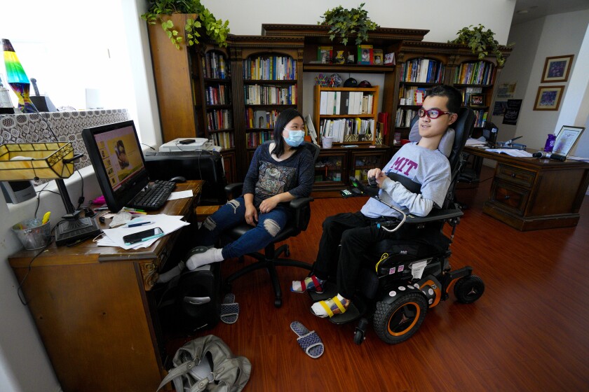 At his home in Poway, Ben Lou, 18 spends the day with his mother, Jenny Huang.  