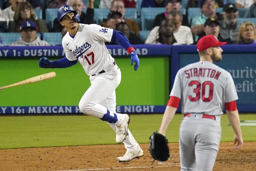Los Angeles Dodgers' Miguel Vargas, left, heads t first after hitting a two-run home run as St. Louis Cardinals.