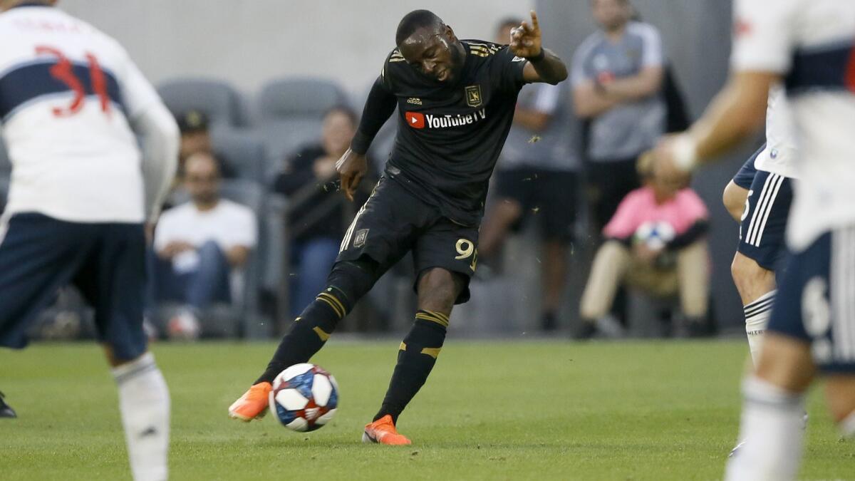 LAFC forward Adama Diomand takes a shot during a game.