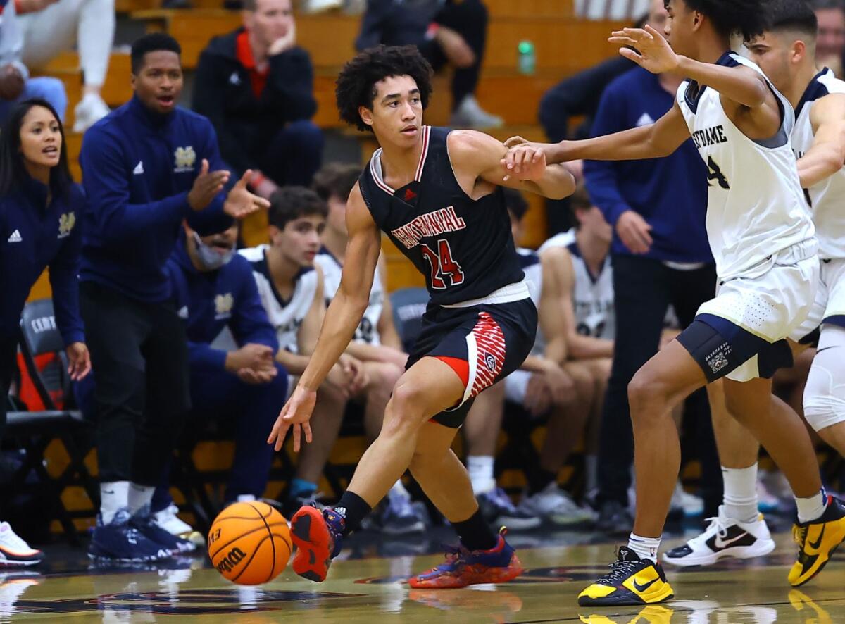 Jared McCain dribbles against Sherman Oaks Notre Dame players.