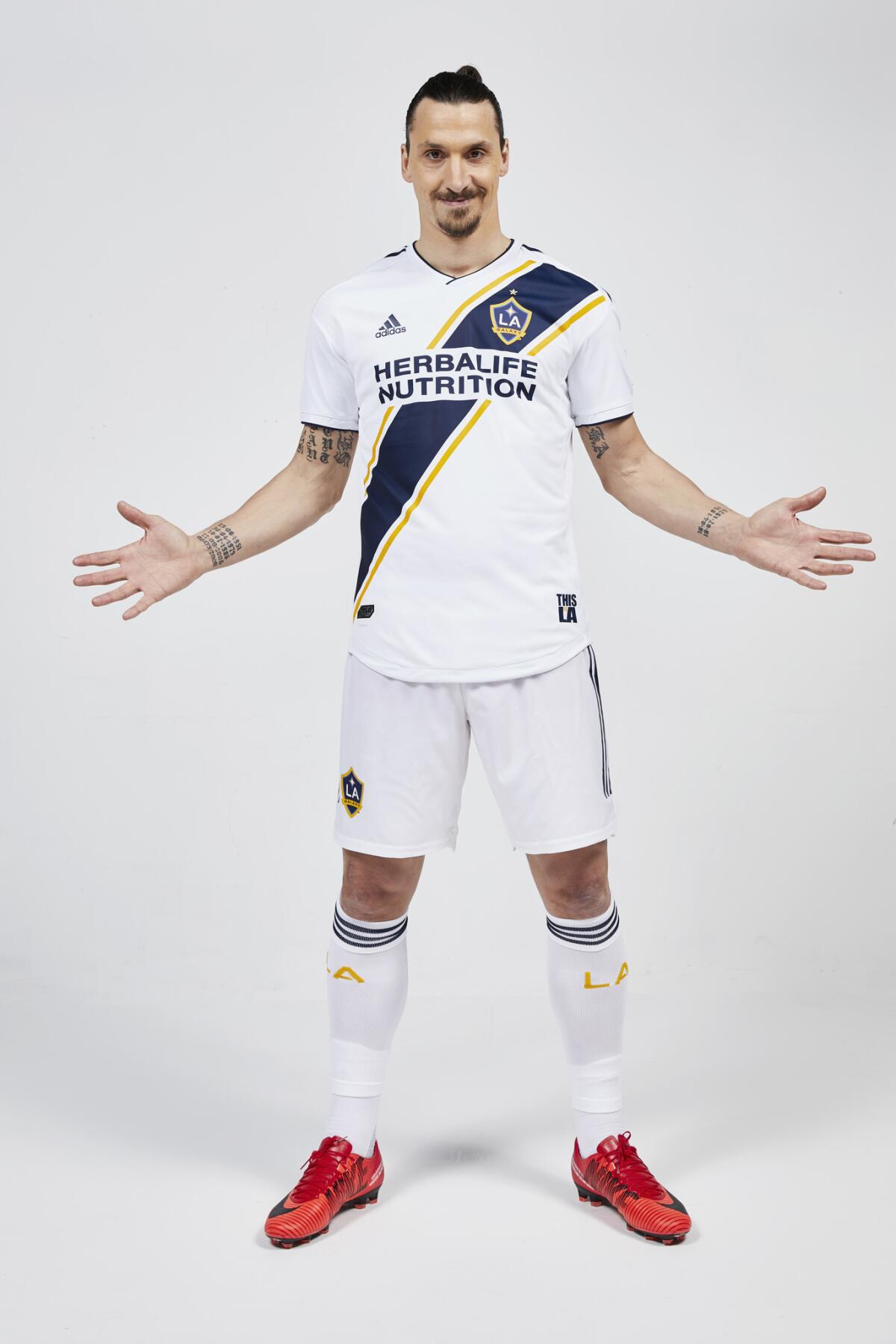 In this photo provided Friday, March 23, 2018, by the LA Galaxy, forward Zlatan Ibrahimovic, of Sweden, poses in the uniform of his new club. The 36-year-old forward comes to the MLS soccer club from Manchester United, where he played for two seasons. He made 53 appearances with the club, scoring 29 goals.