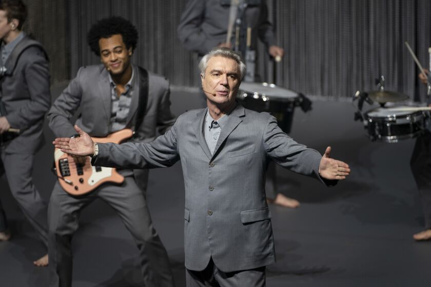David Byrne in a production still from "David Byrne's American Utopia." Directed by Oscar® and Emmy® winning director Spike Lee, theone-of-a-kind, dynamic film gives audiences around the world access to Byrne'selectrifying Broadway show that played to sold-out, record-breaking audiences during itsrun from October 2019 to February 2020 at Broadway's Hudson Theater.