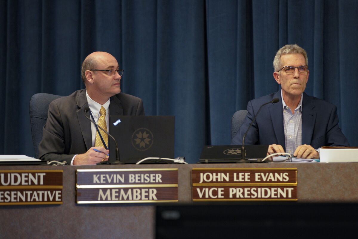 San Diego Unified School District board member Kevin Beiser (left) sits next to member John Lee Evans in April 2019.