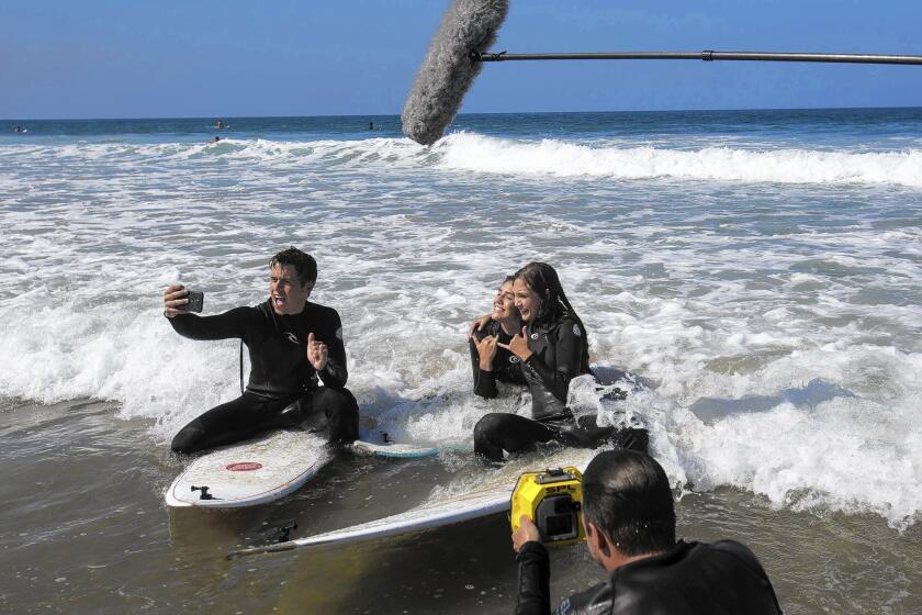 "@SummerBreak" cast members Dash, Baylynne and Ava practice standing on surfboards. The show is in its second season.