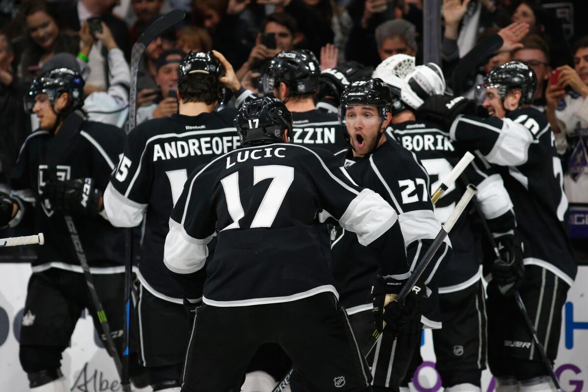Kings teammates Milan Lucic (17) and Alec Martinez (27) react after beating the Blackhawks, 3-2, in overtime.