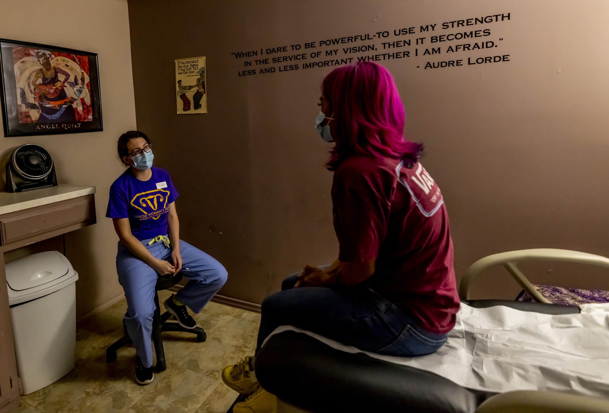 A female doctor, left, discusses options with a female patient after an ultrasound confirmed her pregnancy. 