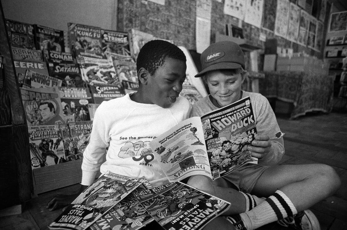 Comic book fans Freddie Lewis, 12, left, and Marshall Beck, 12, both of Normal Heights, set aside superhero comics to check out a copy of "Howard the Duck" in 1976.