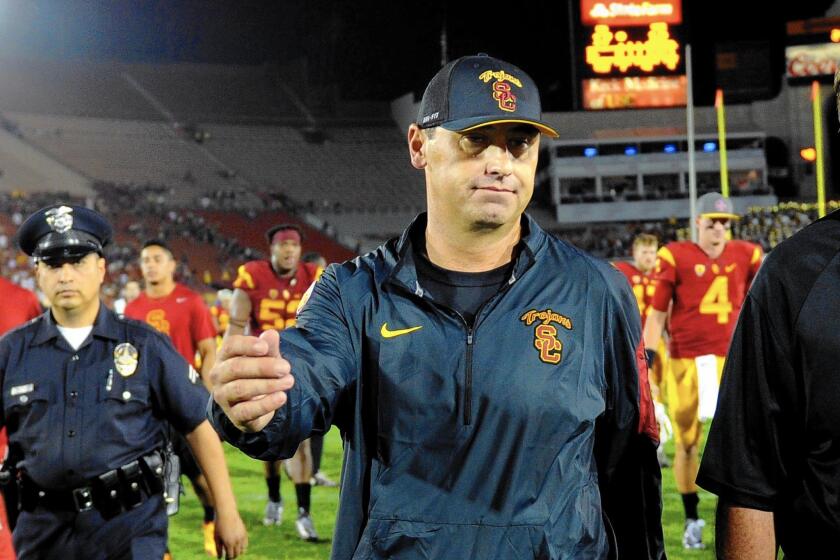 USC Coach Steve Sarkisian walks off the field after losing to Washington at the Coliseum.
