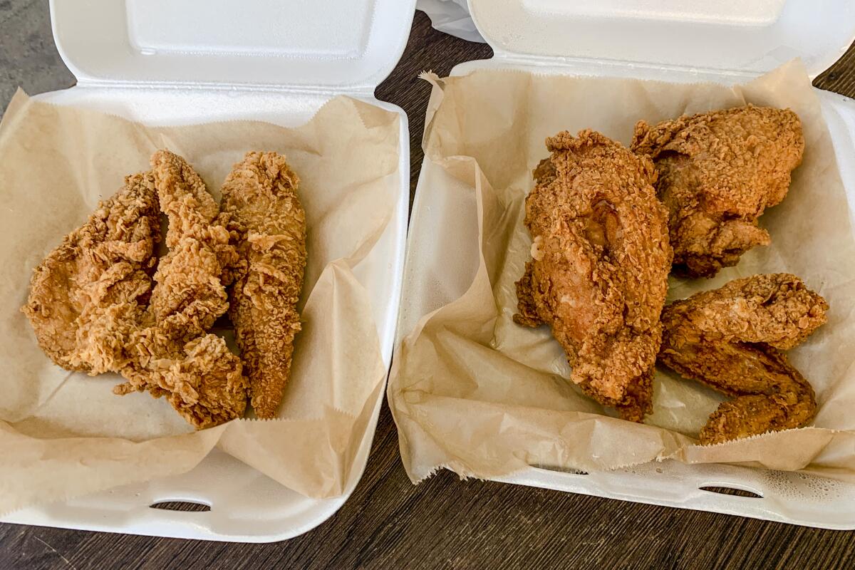 Two to-go containers of fried chicken