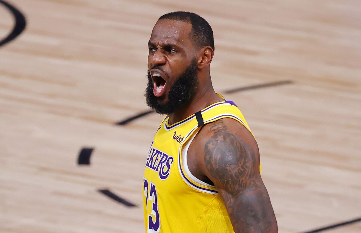 Lakers star LeBron James reacts after a dunk during the third quarter of the Lakers' 111-88 victory in Game 2 on Thursday.