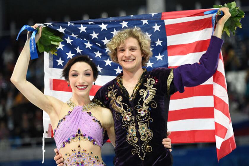 Americans Meryl Davis, left, and Charlie White celebrate after winning the gold medal in ice dance at the Sochi Winter Olympic Games on Monday.
