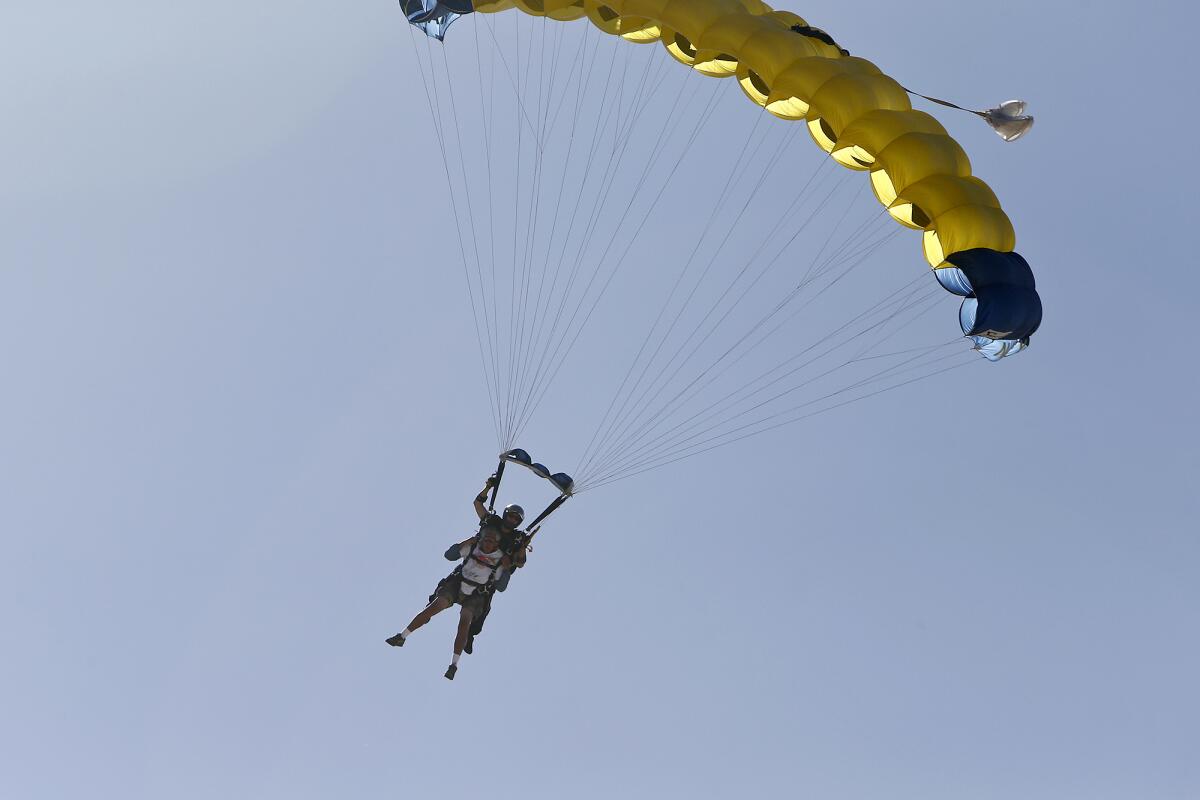 Don Ramsey glides in for a landing after tandem jumping out of a plane with the U.S. Navy Leap Frogs on Thursday.