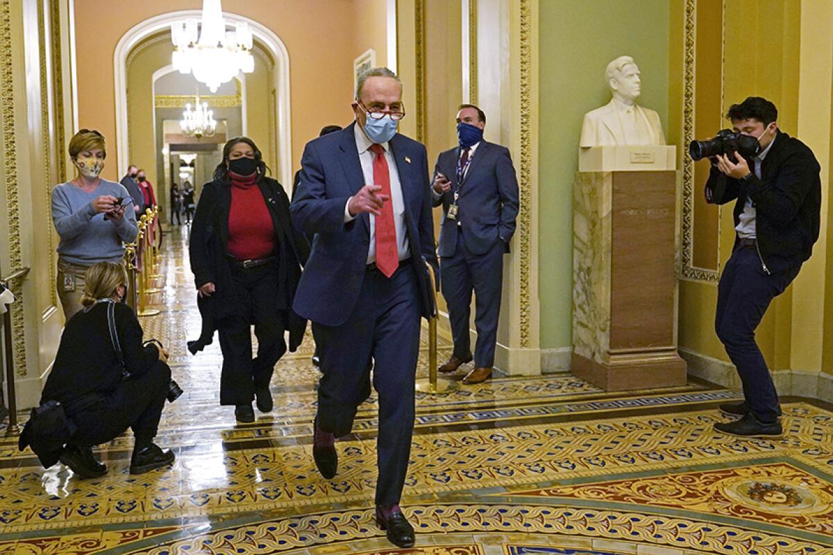 Sen. Charles Schumer (D- N.Y.) walks through the Capitol
