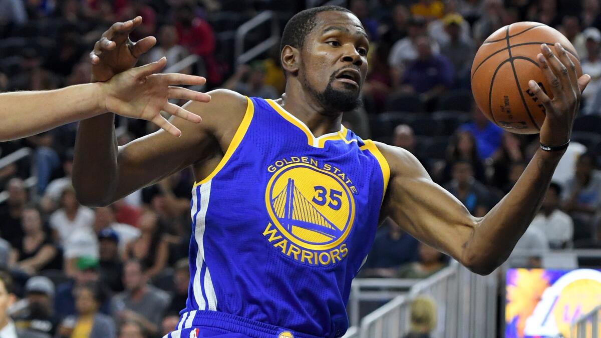 Golden State's Kevin Durant grabs a rebound during an exhibition game against the Lakers on Saturday.