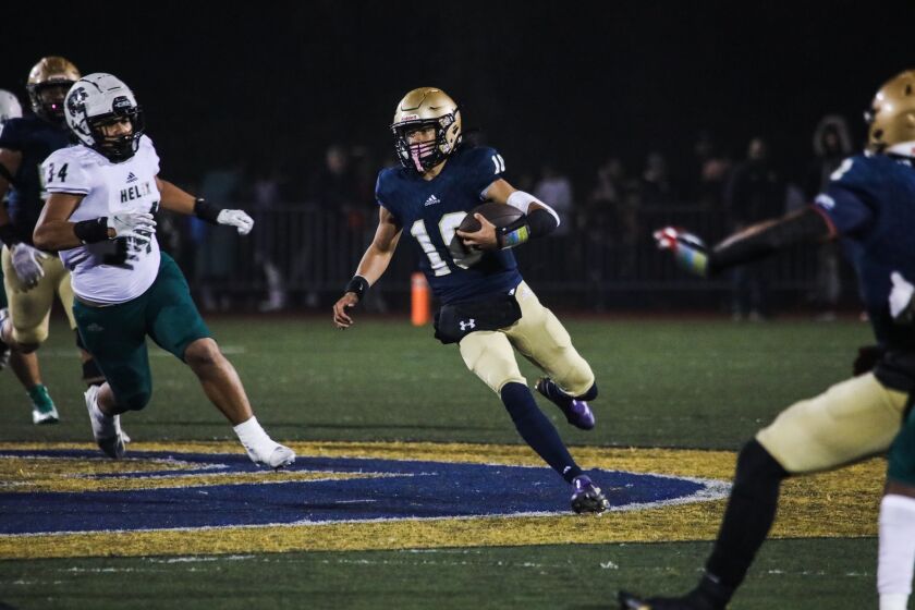 Mater Dei Catholic High’s quarterback Domonic Nankil runs with the ball against Helix High during the state playoffs on Friday, Dec. 3, 2021. Mater Dei defeated Helix High 24 - 21.