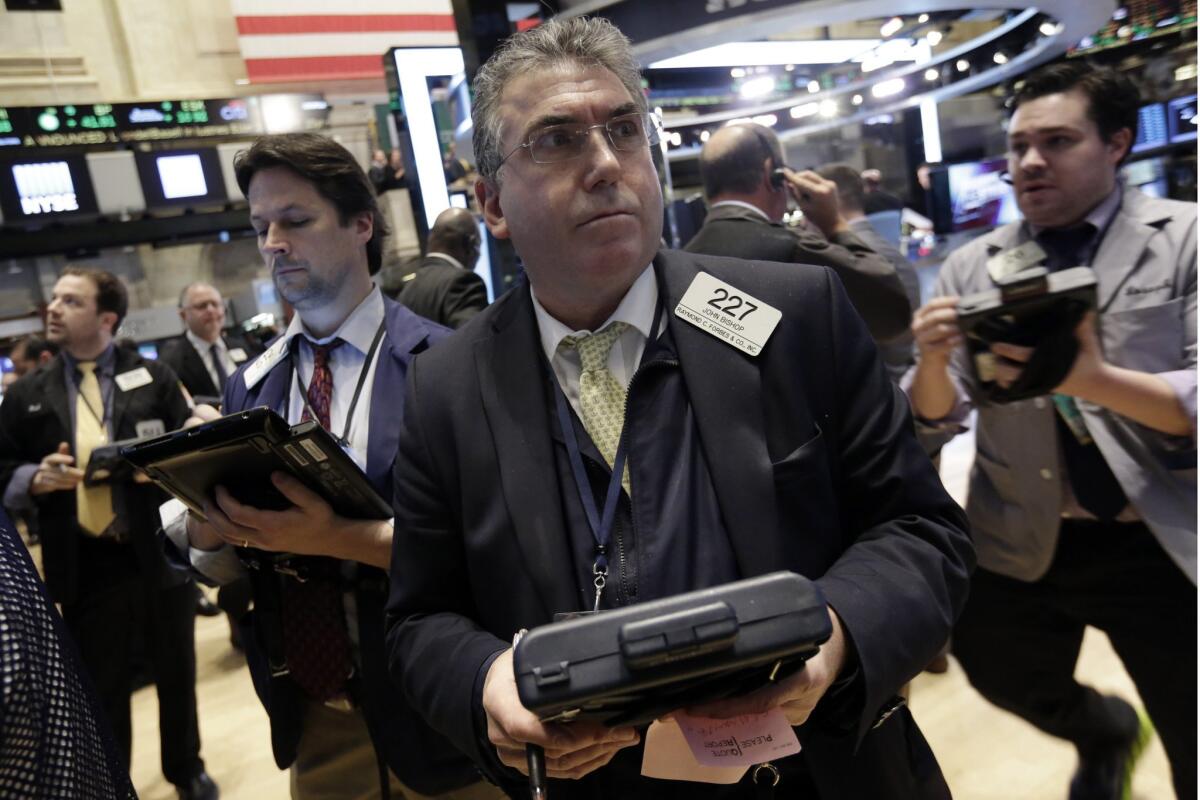 Trader John Bishop works on the floor of the New York Stock Exchange Thursday. A new poll says Americans see significant improvements in jobs and the market, but worry about the economy's vulnerability to another financial crisis.